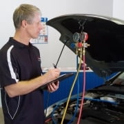 man-inspecting-cooling-system