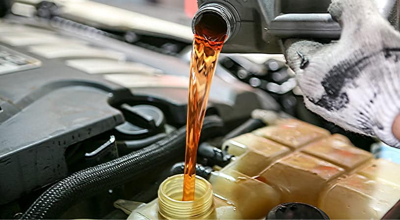 pouring coolant into tank
