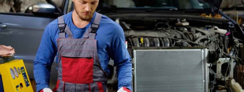 Mechanic inspecting car radiator for EV battery thermal management and cooling system service.