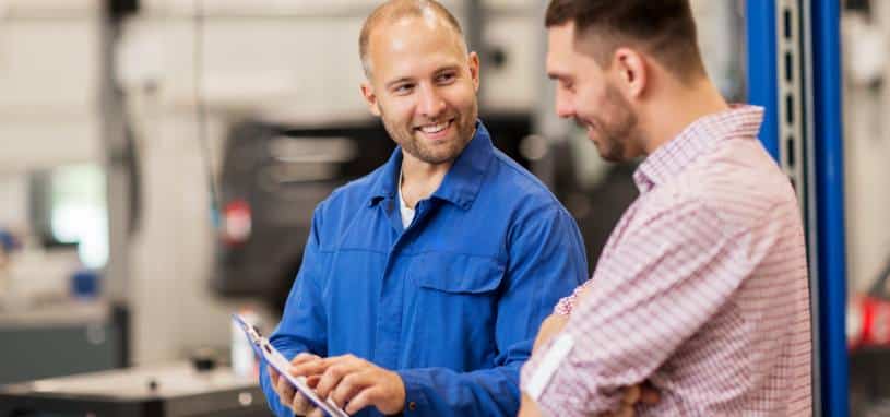 Mechanic talking to man