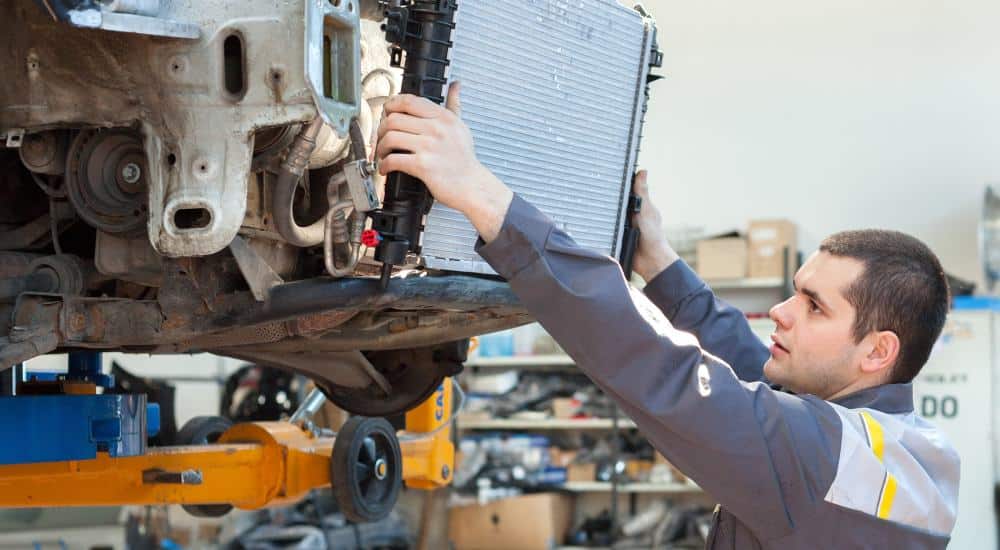 mechanic changing radiator