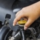 person turning car radiator cap