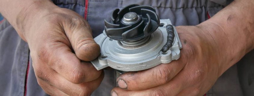 mechanic handling a water pump