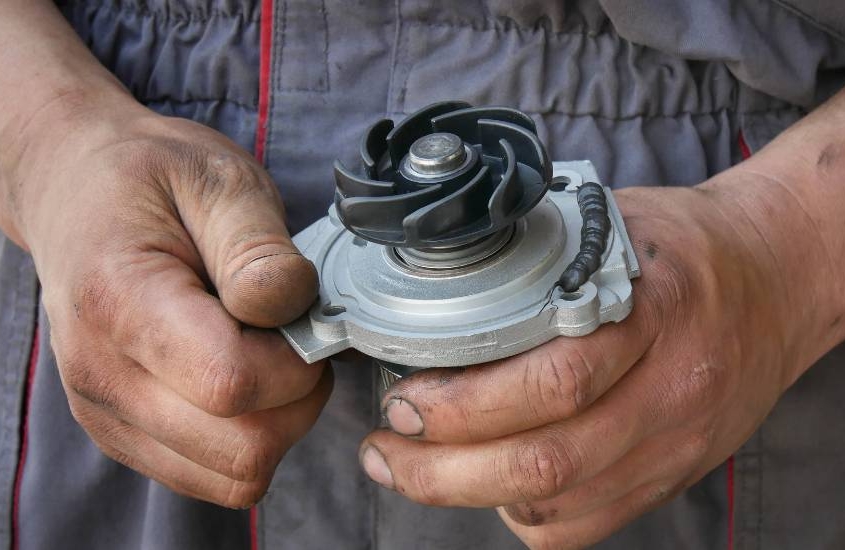 mechanic handling a water pump