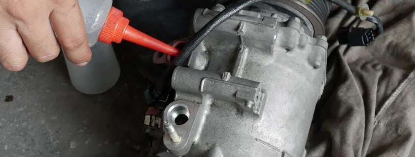 auto mechanic checking car air conditioner