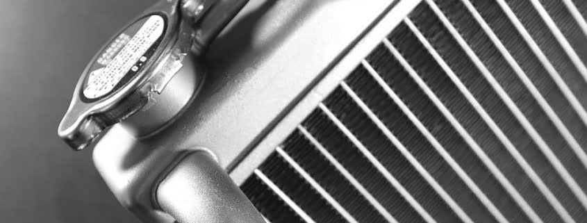 A close-up of the cap on a car radiator.