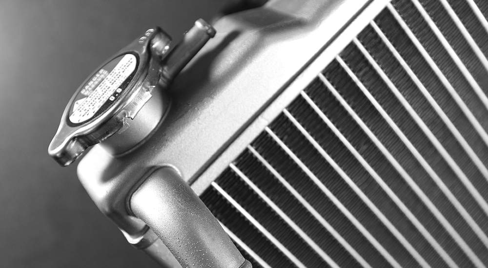 A close-up of the cap on a car radiator.