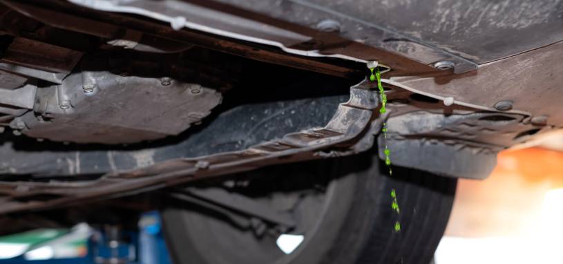 Close up of green fluorescent coolant liquid leaked out from the engine coolant
