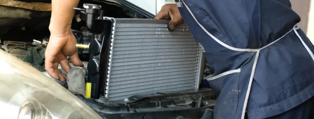 What is the function of a car radiator?